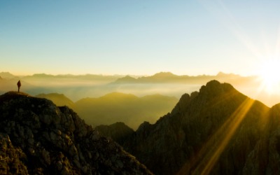 standing on mountain observing sunset